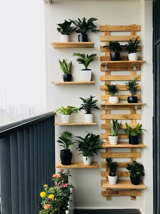  Vertical wall-mounted planters with herbs and greenery on a small balcony 
